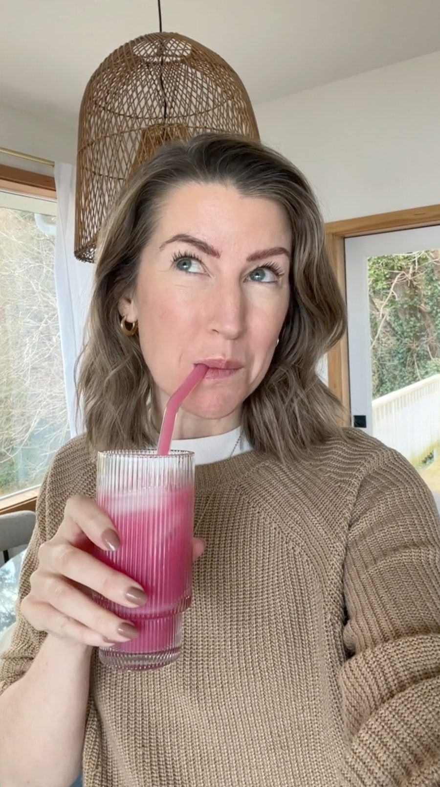 Woman sipping Ü Relax through a straw